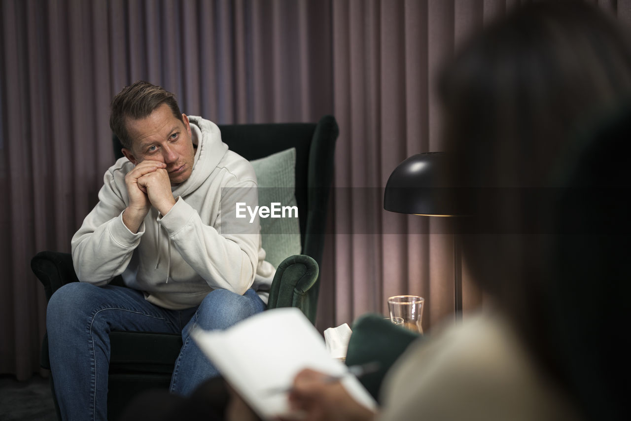 Man sitting in armchair at therapy session