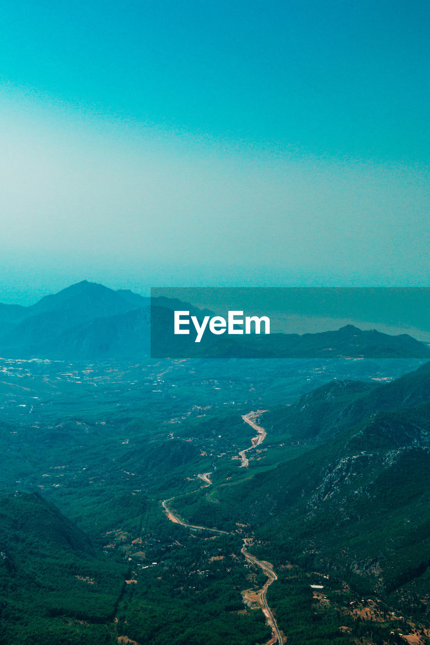 Aerial view of landscape and mountains against clear sky