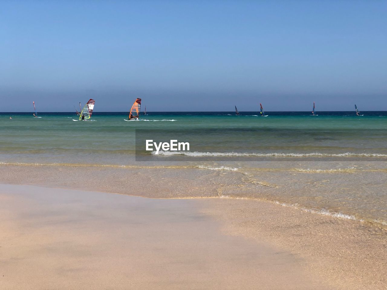 VIEW OF PEOPLE ON BEACH AGAINST SKY