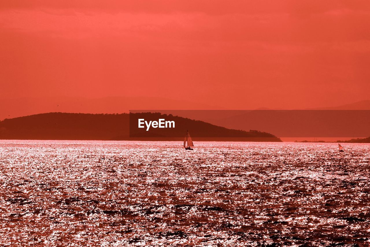 Lone boat in calm sea against clear sky