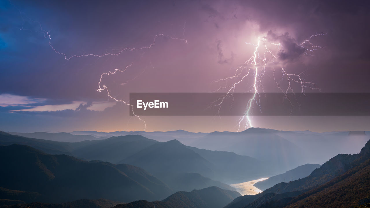 View of lightning over mountains against sky