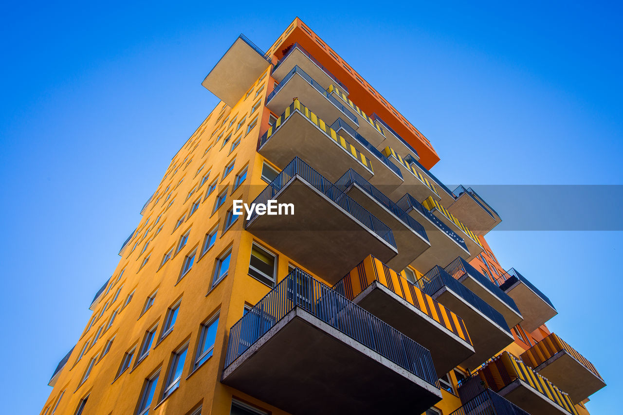 LOW ANGLE VIEW OF TRADITIONAL BUILDING AGAINST BLUE SKY