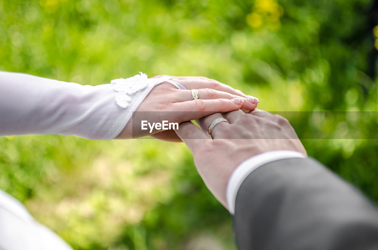 Cropped image of newlywed couple hands