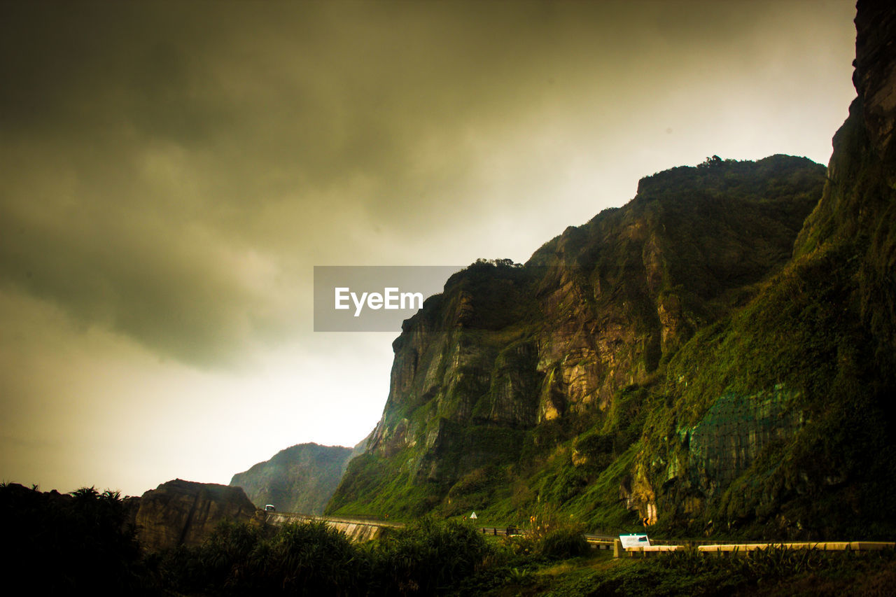 Scenic view of mountains against cloudy sky