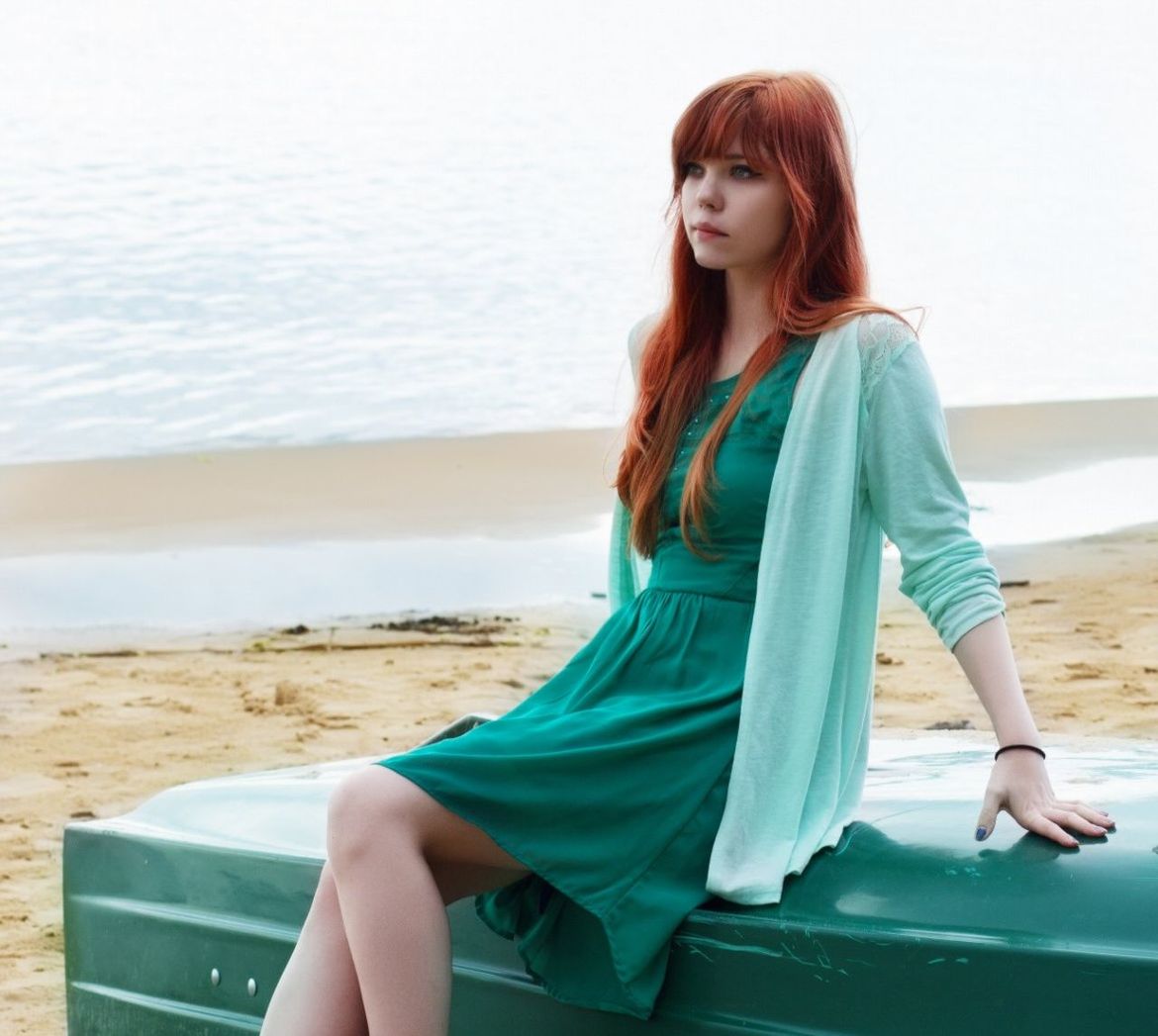 Beautiful red hair woman at beach