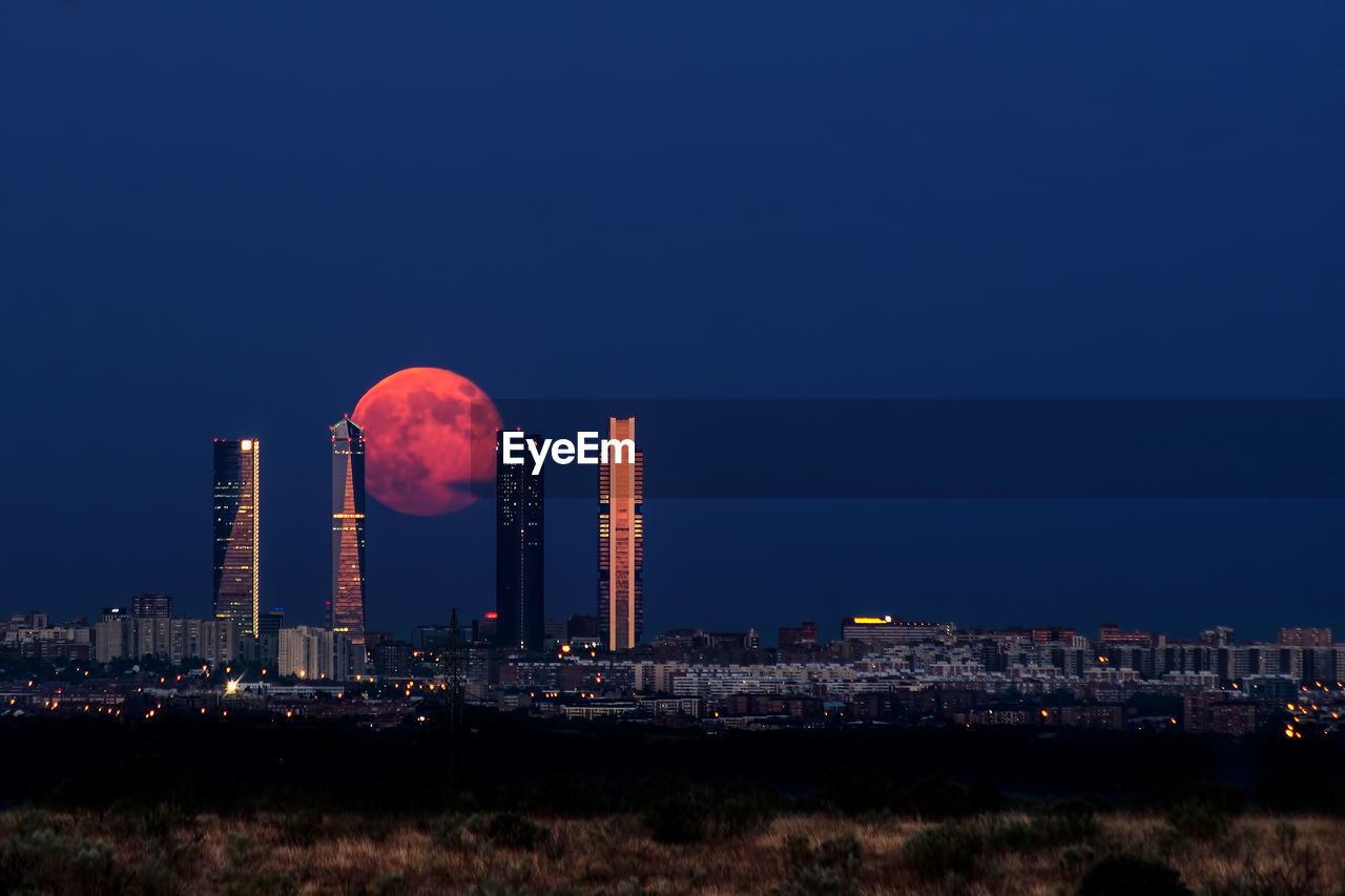 Full moon rising between ctba madrid