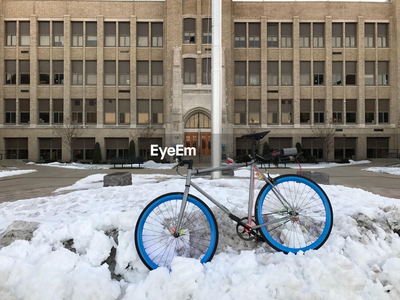 BICYCLE PARKED IN FRONT OF SNOW