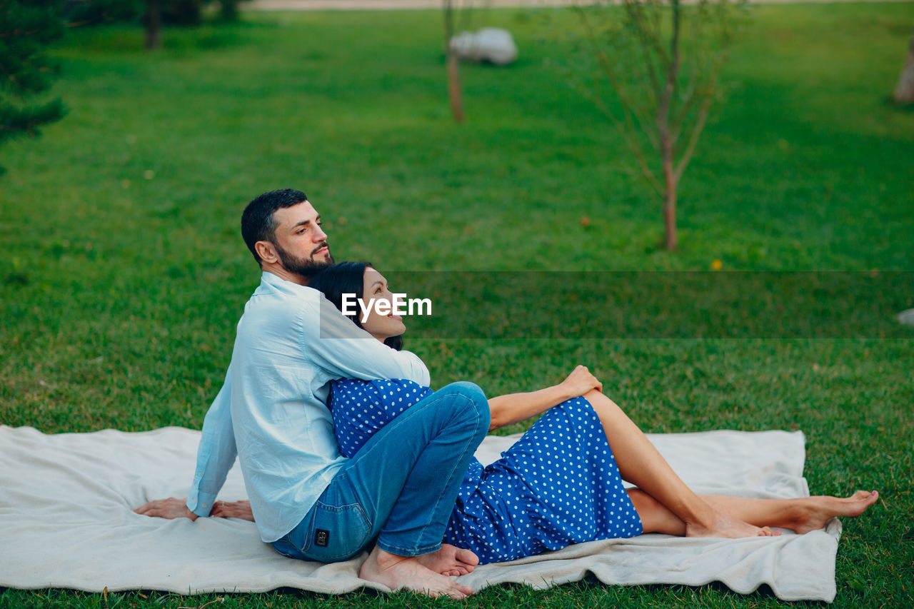 Side view of couple kissing on land