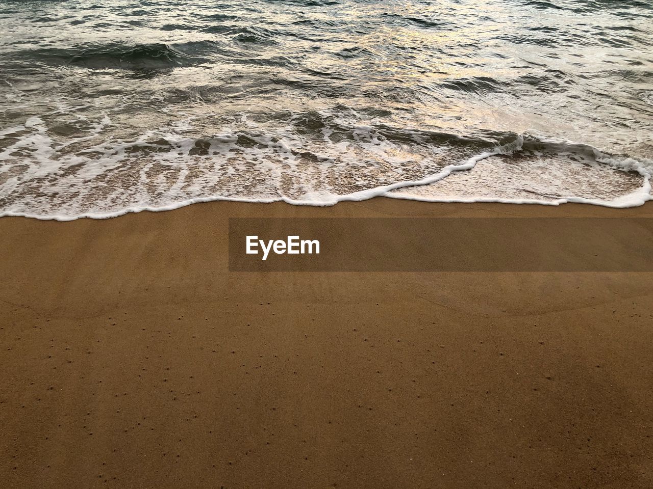 HIGH ANGLE VIEW OF WAVES RUSHING ON SHORE