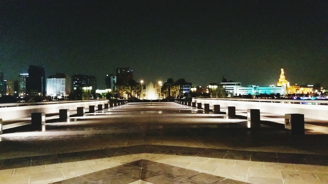 ILLUMINATED STREET LIGHTS IN CITY AT NIGHT