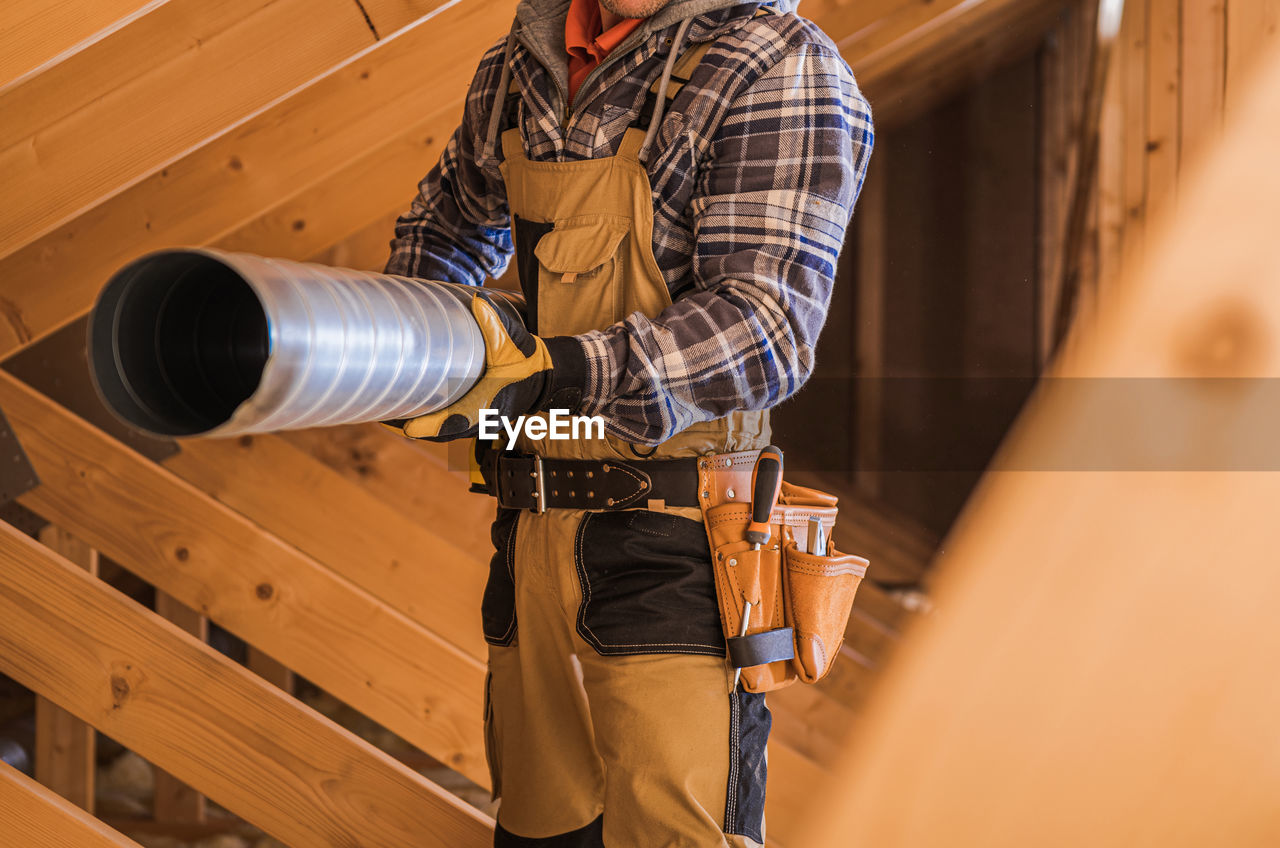 rear view of man standing in workshop