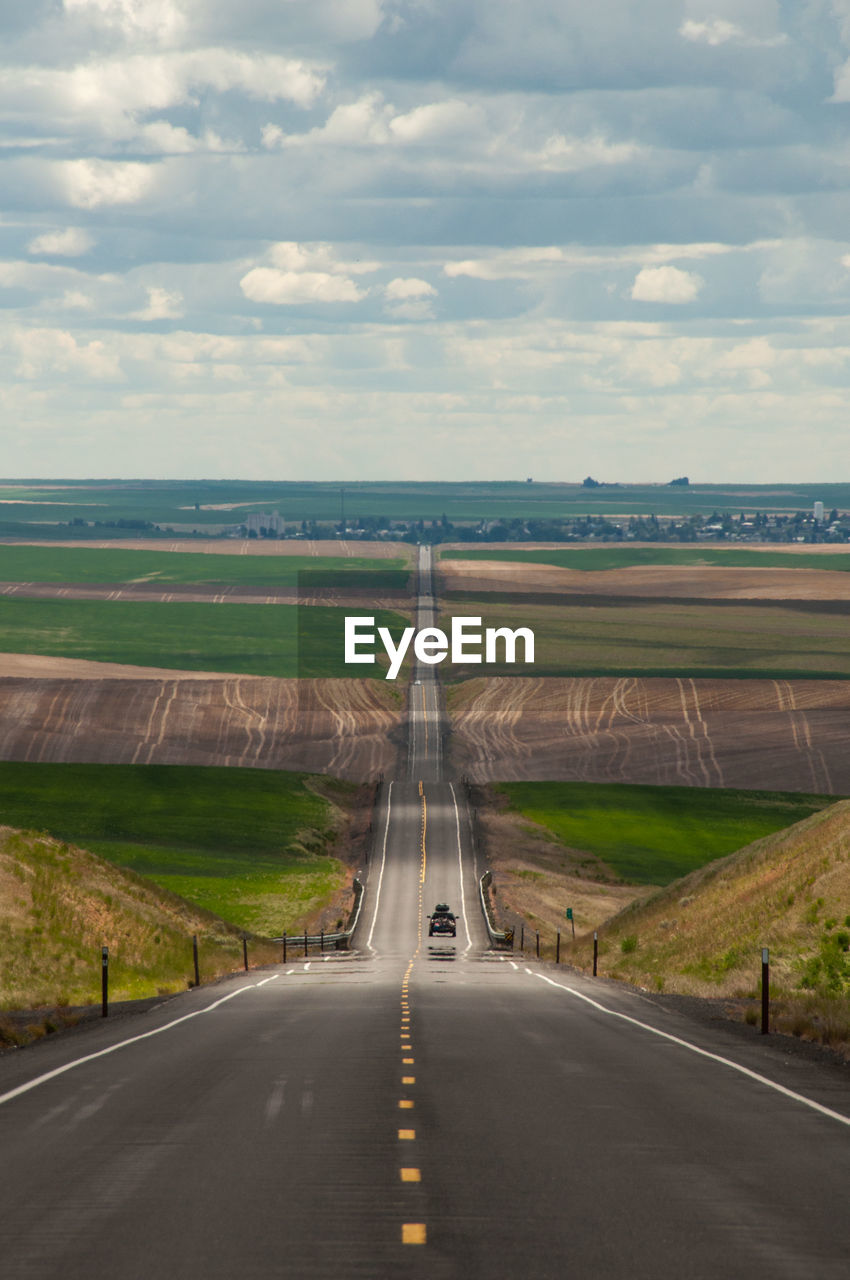 Road amidst landscape against sky