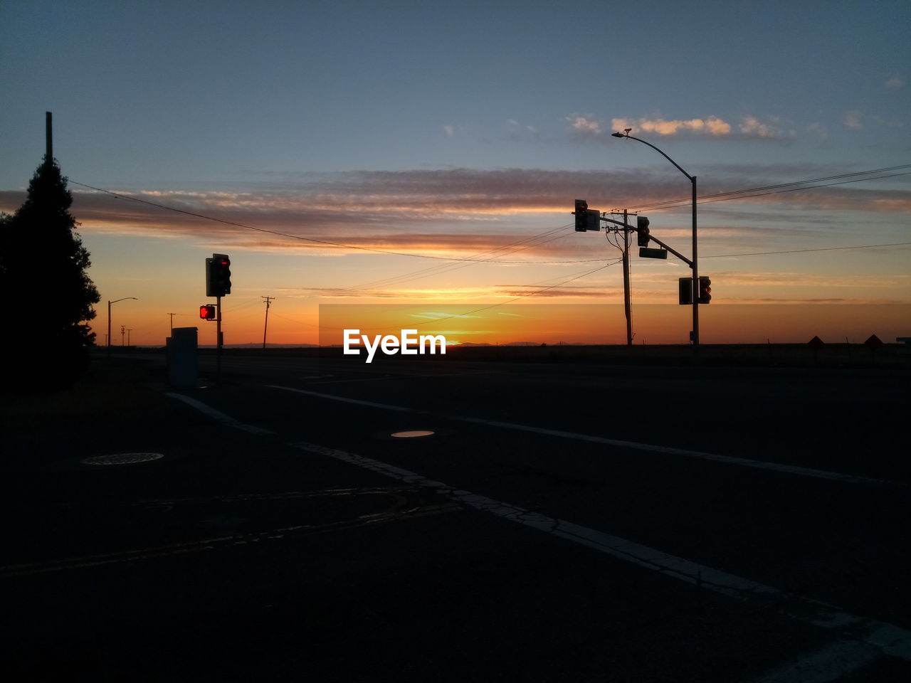 SILHOUETTE OF STREET AGAINST SKY DURING SUNSET