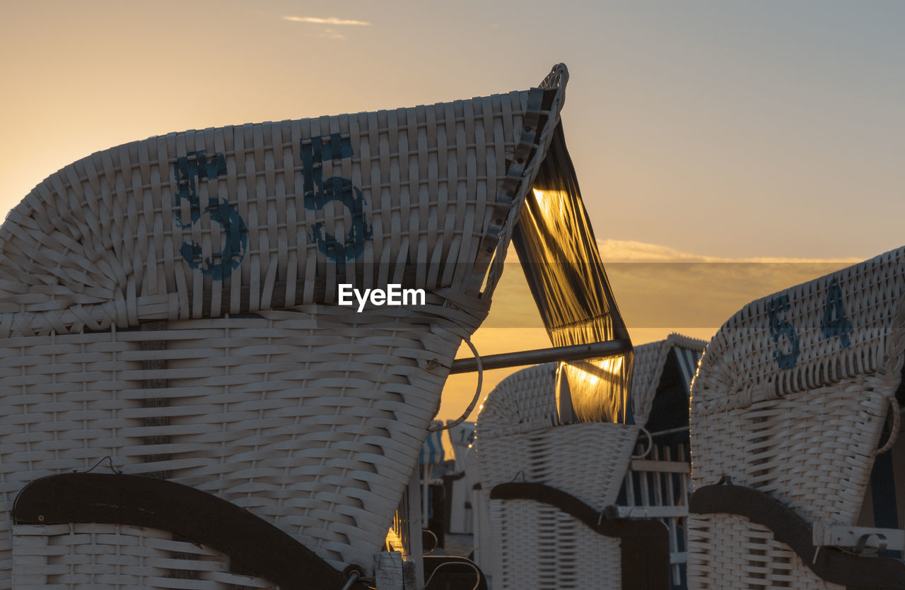 Numbers on hooded beach chairs during sunset