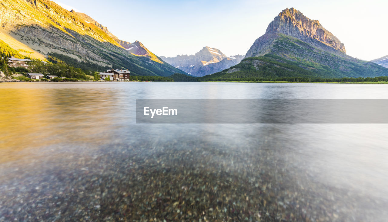 SCENIC VIEW OF LAKE BY MOUNTAIN AGAINST SKY