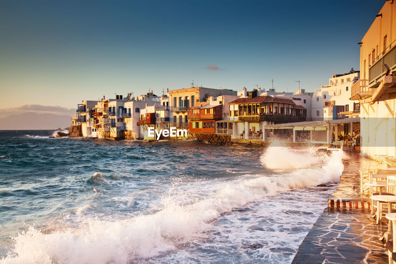 BUILDINGS ON BEACH AGAINST CLEAR SKY