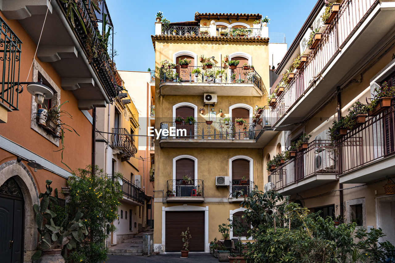 View of a beautiful town of taormina in sicily. architecture of buildings with planted plants