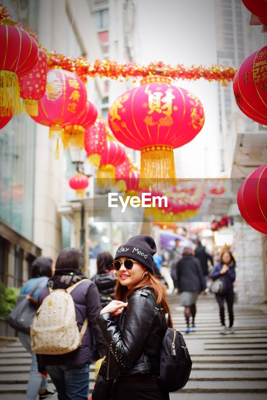 Woman in sunglasses standing at market