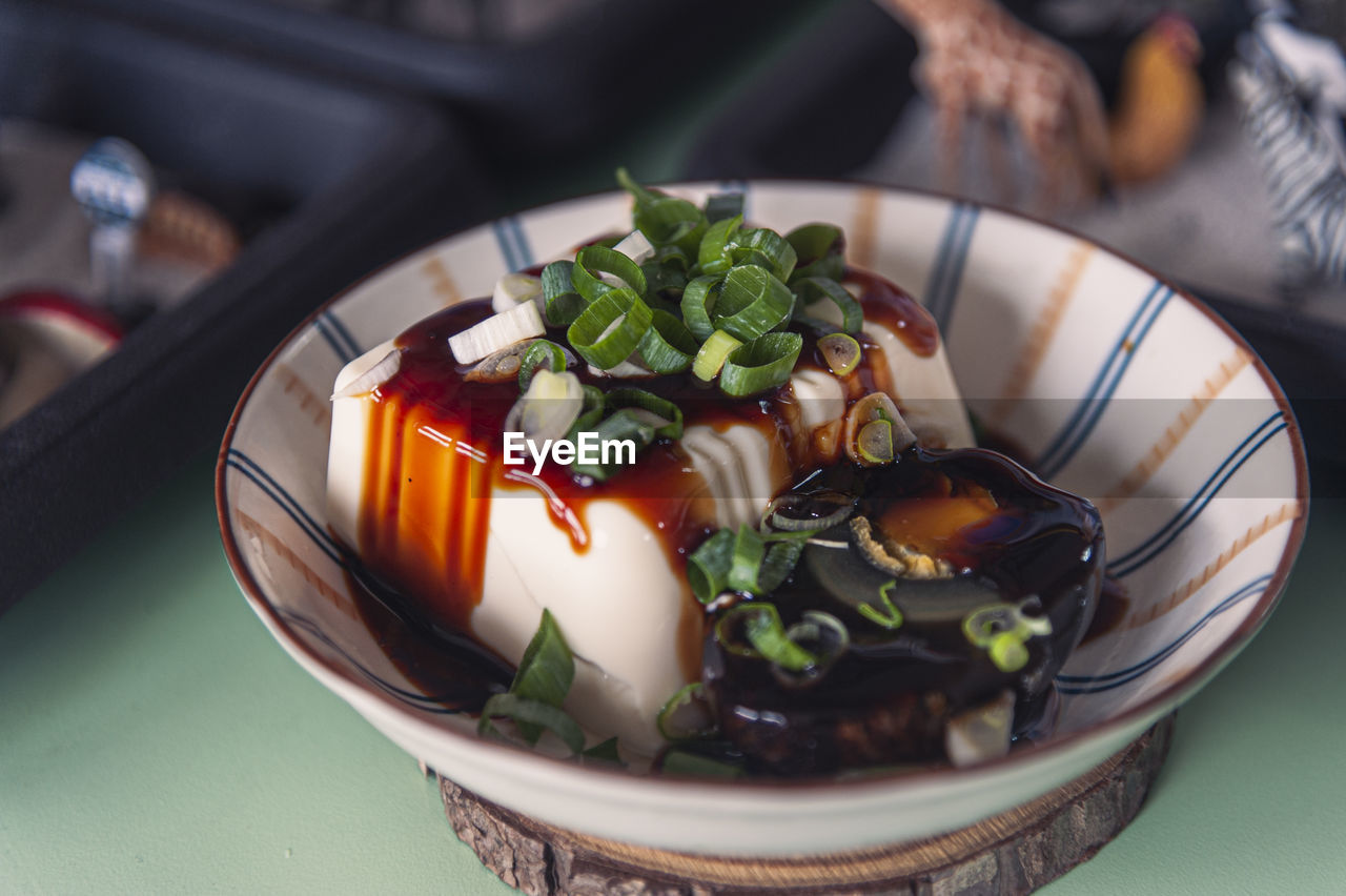 High angle view of century egg and tofu in bowl on table