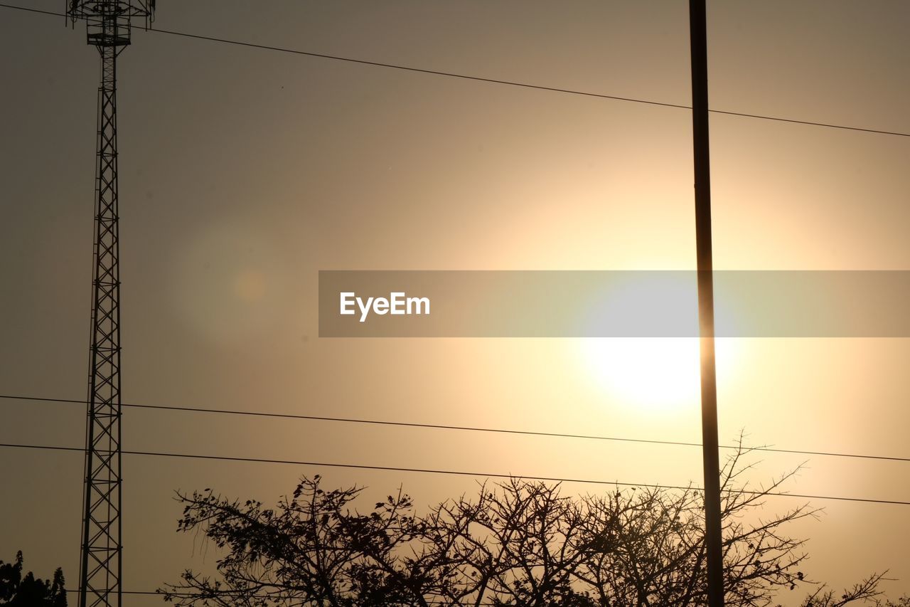 LOW ANGLE VIEW OF SILHOUETTE ELECTRICITY PYLON AGAINST SKY DURING SUNSET