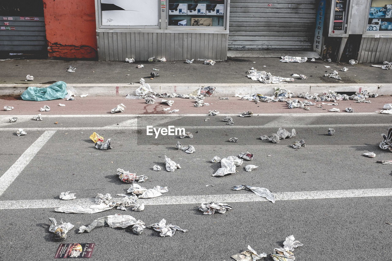 High angle view of messy street against stores