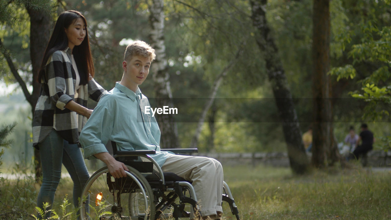 Young woman with handicapped boyfriend at park