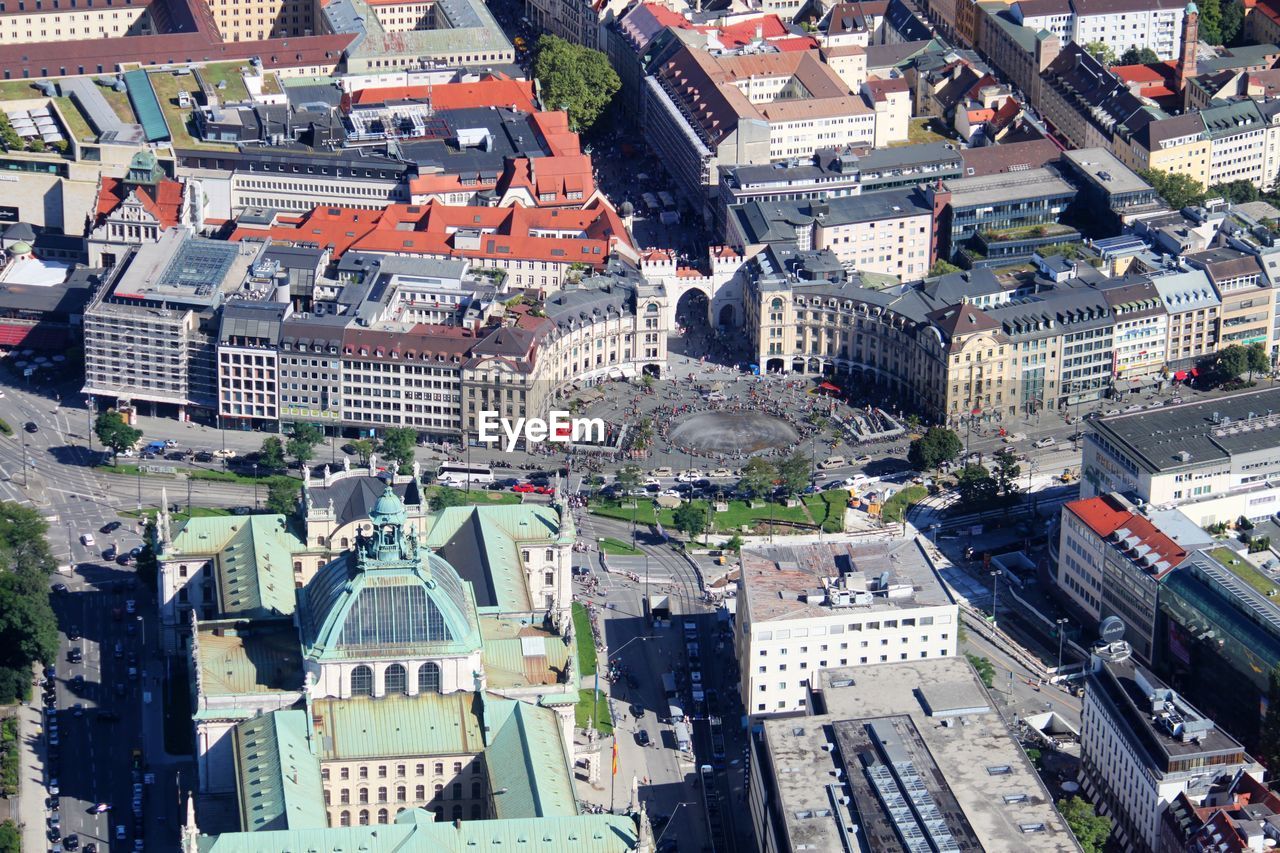 Aerial view of buildings in city during sunny day