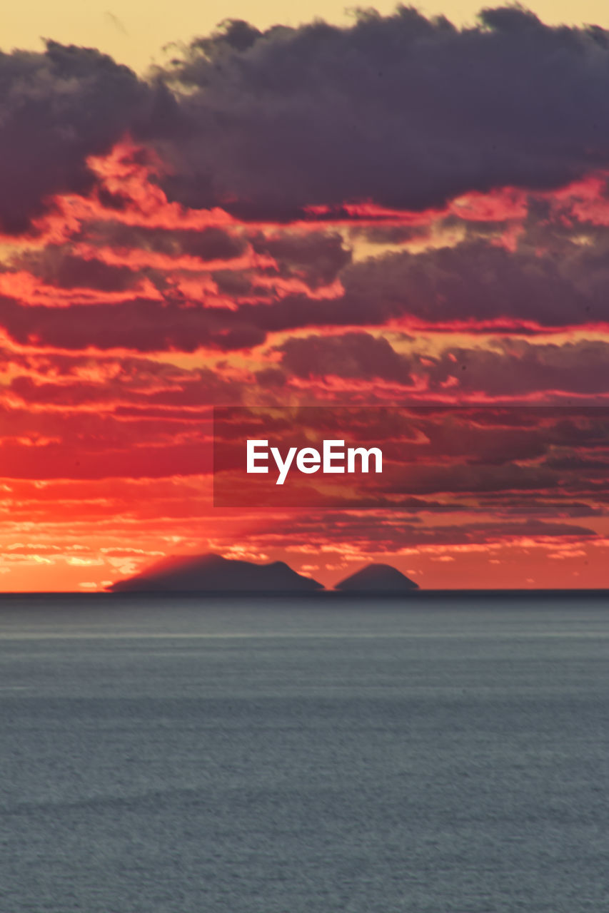 SCENIC VIEW OF SEA AGAINST ORANGE SKY