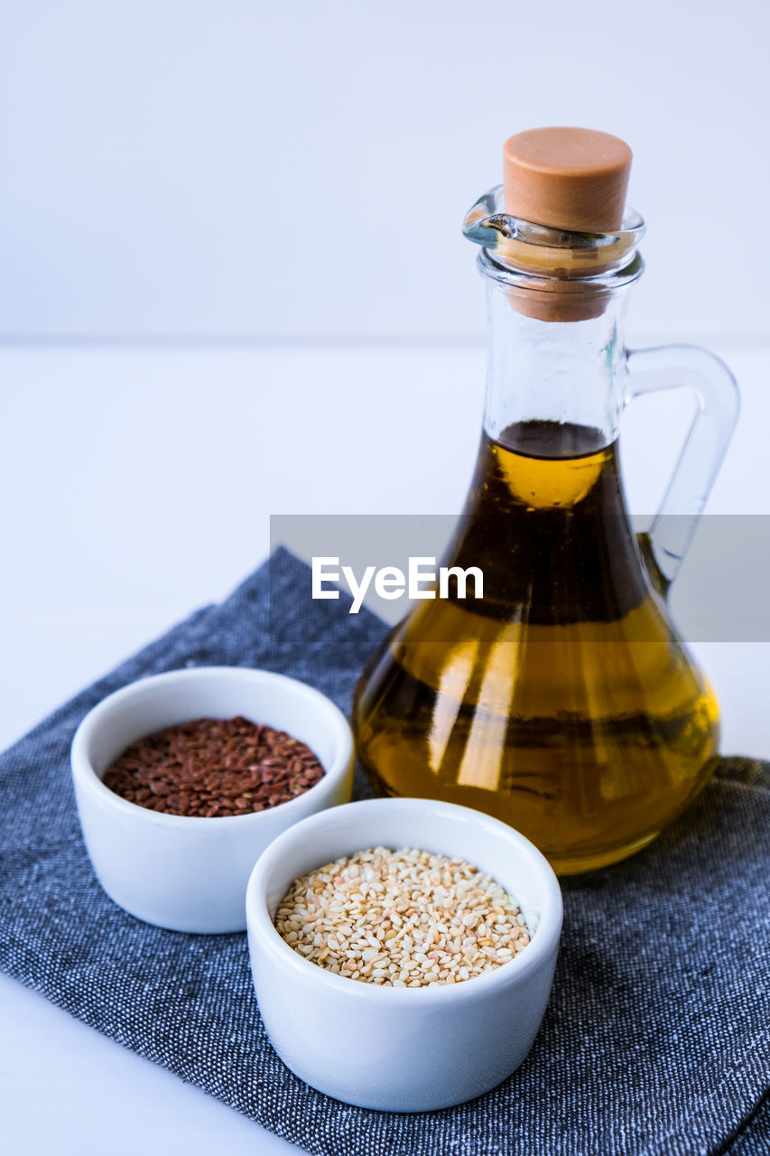 Sesame and flax seeds with oil in glass bottle. healthy food concept. vegan keto diet. healthy 