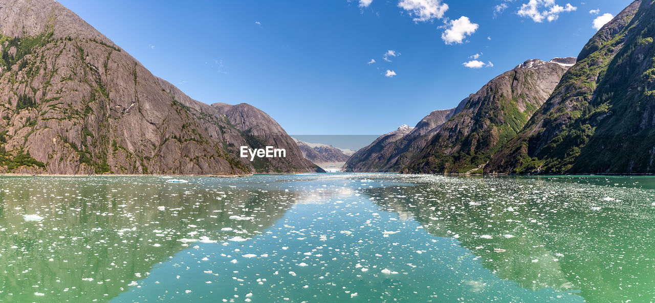 SCENIC VIEW OF SWIMMING POOL BY LAKE AGAINST SKY