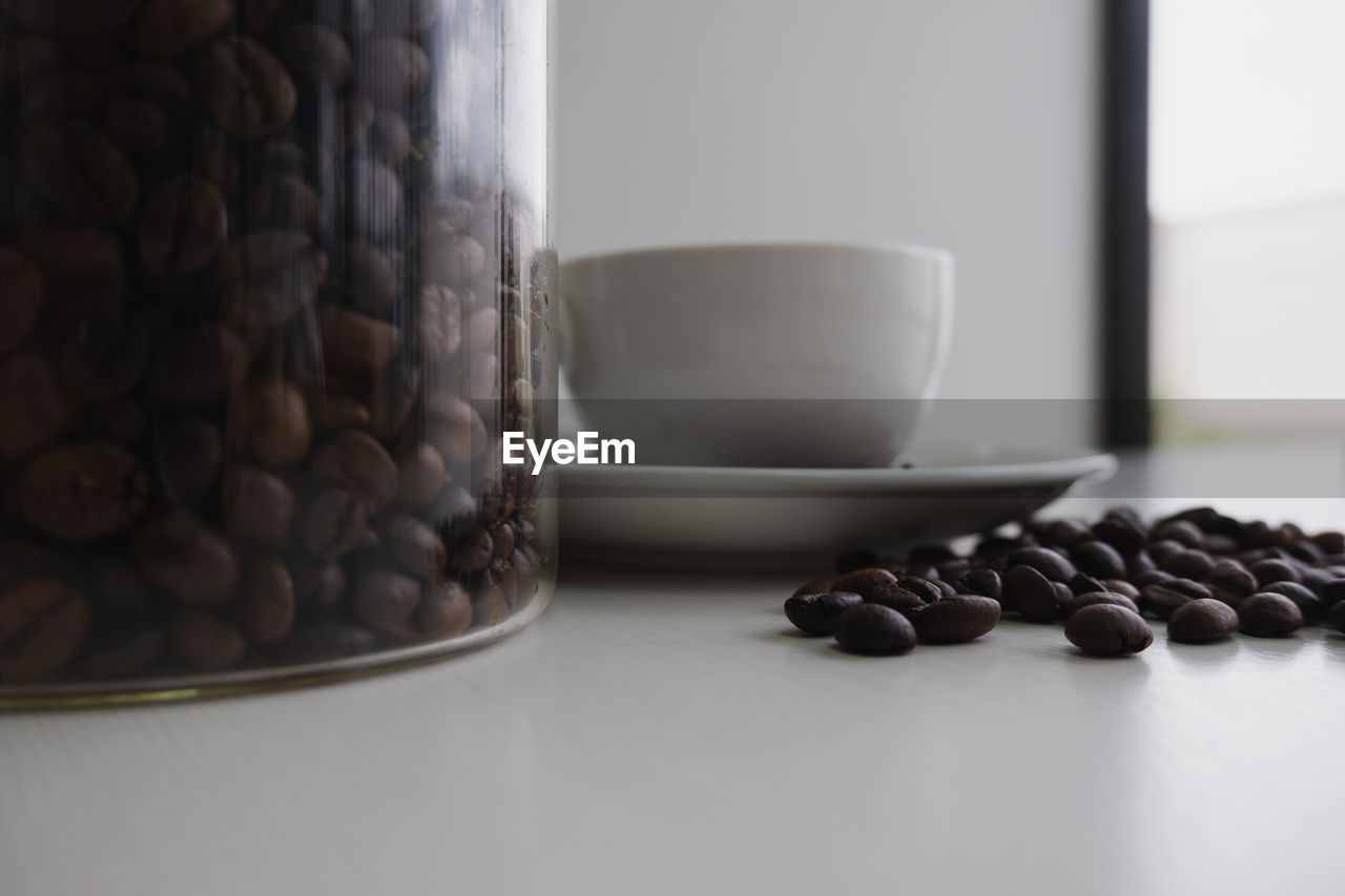 CLOSE-UP OF COFFEE BEANS IN CONTAINER