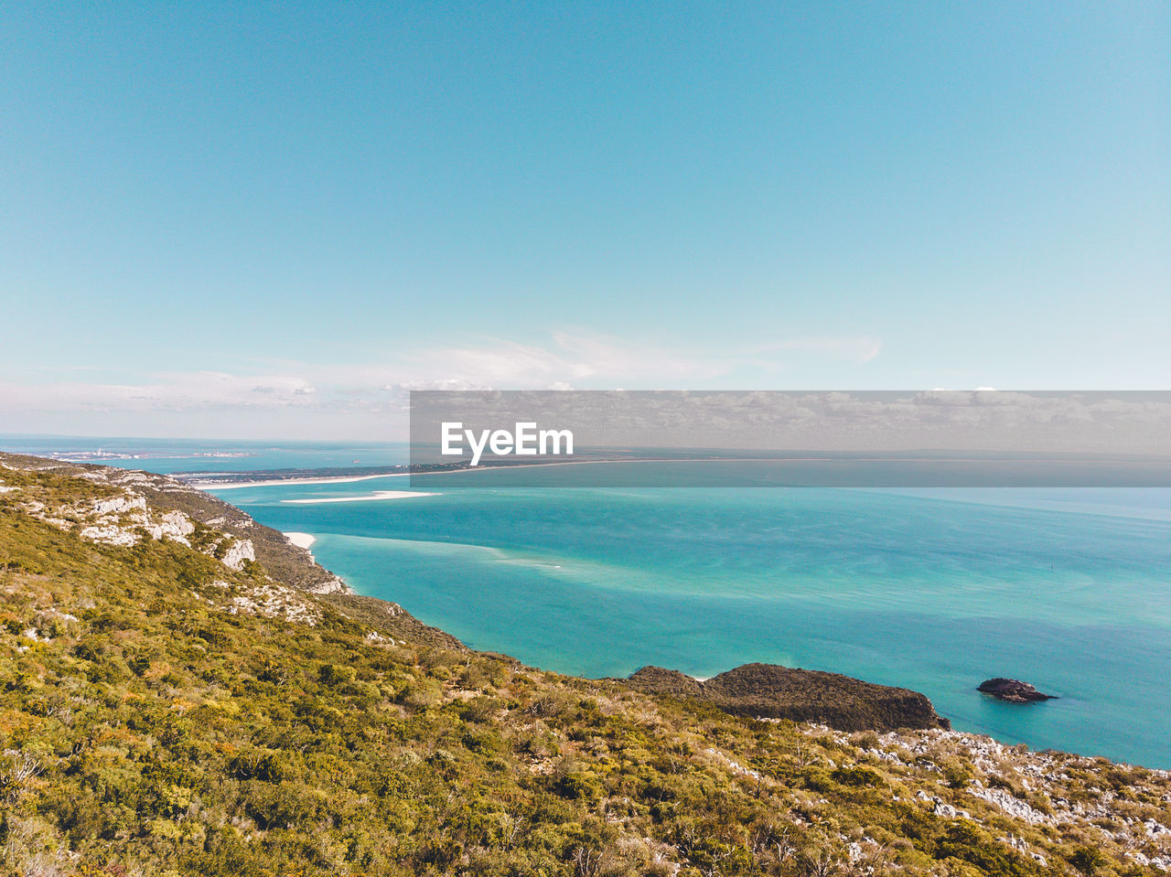 Scenic view of sea against blue sky