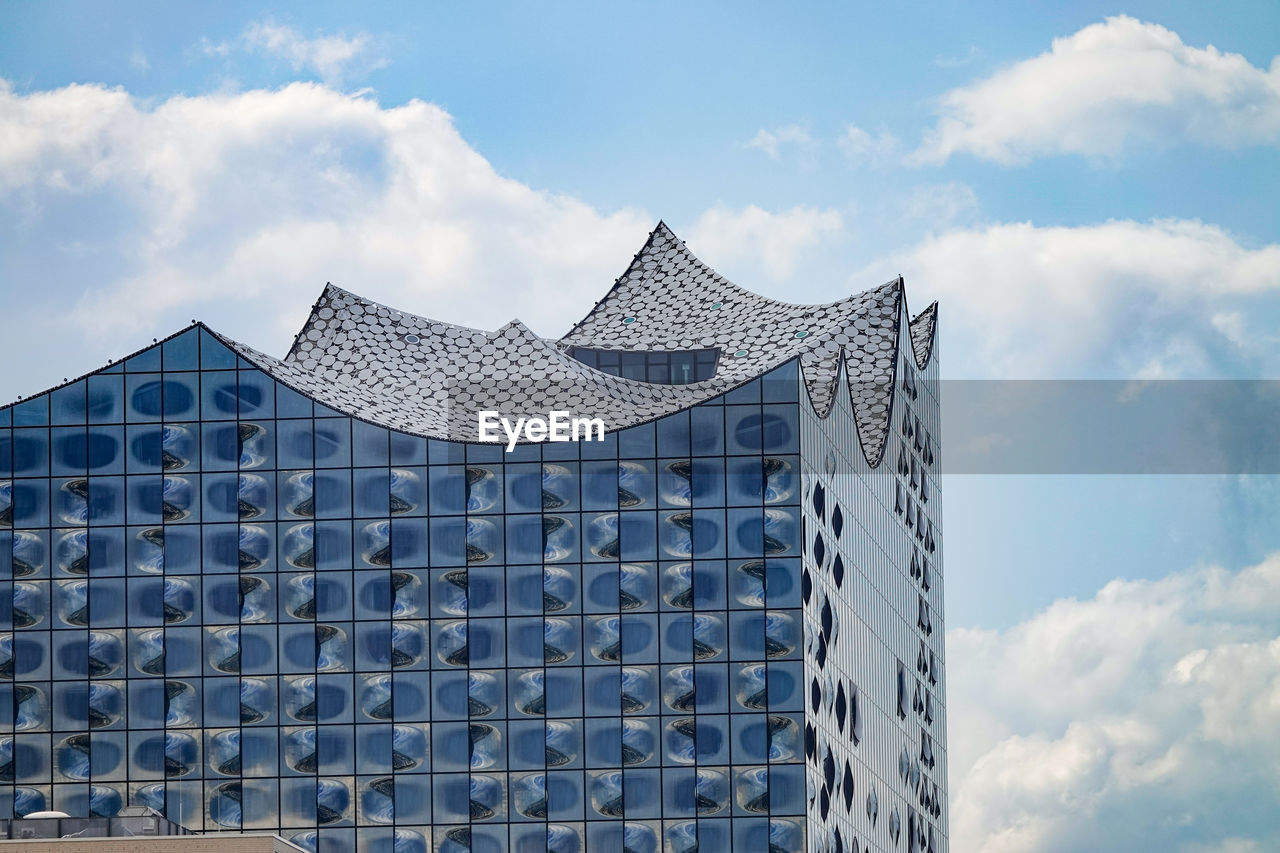 Low angle view of building against cloudy sky