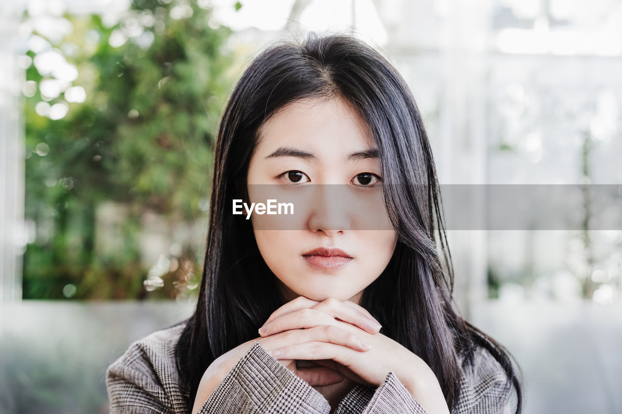 Portrait of confident professional chinese entrepreneur woman in cafeteria. technology, lifestyle