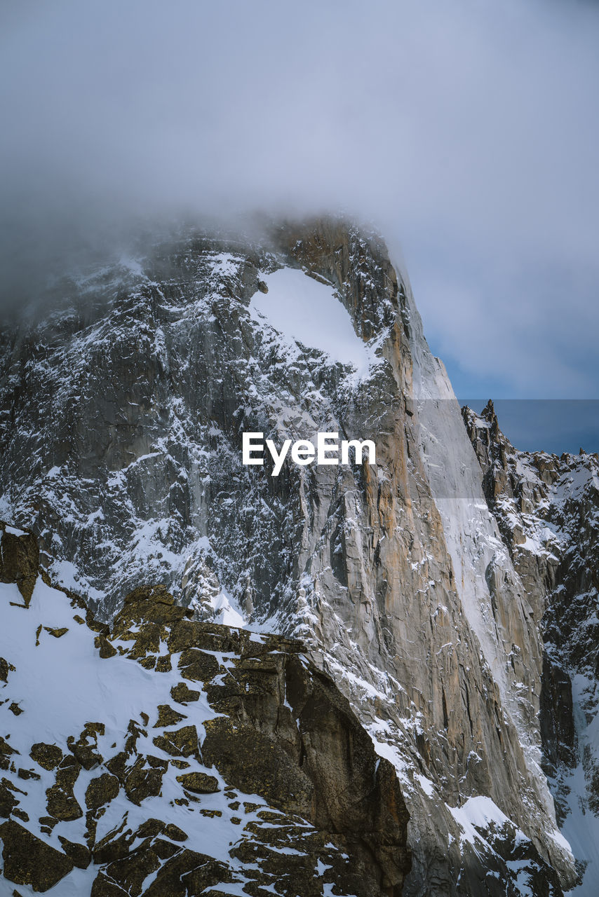 High angle view of snow covered mountains against sky during winter