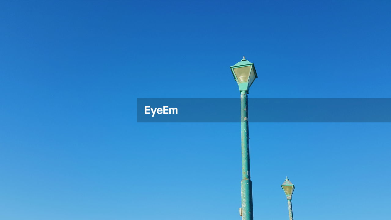 LOW ANGLE VIEW OF STREET LIGHT AGAINST BLUE SKY