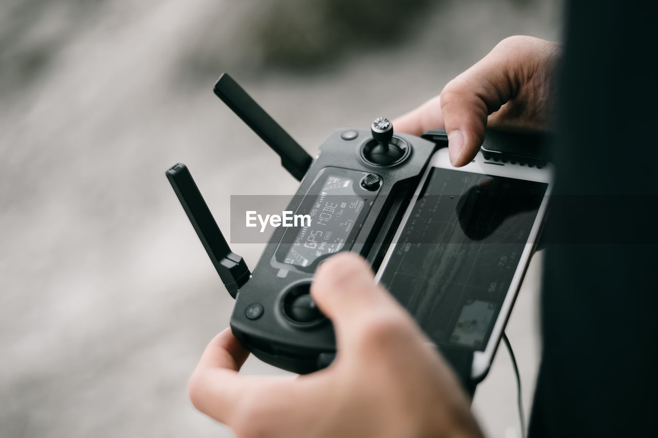 Close-up of person holding remote control