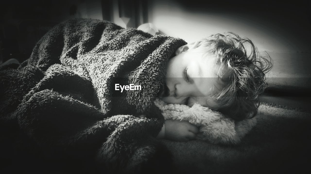 Close-up of boy sleeping on bed