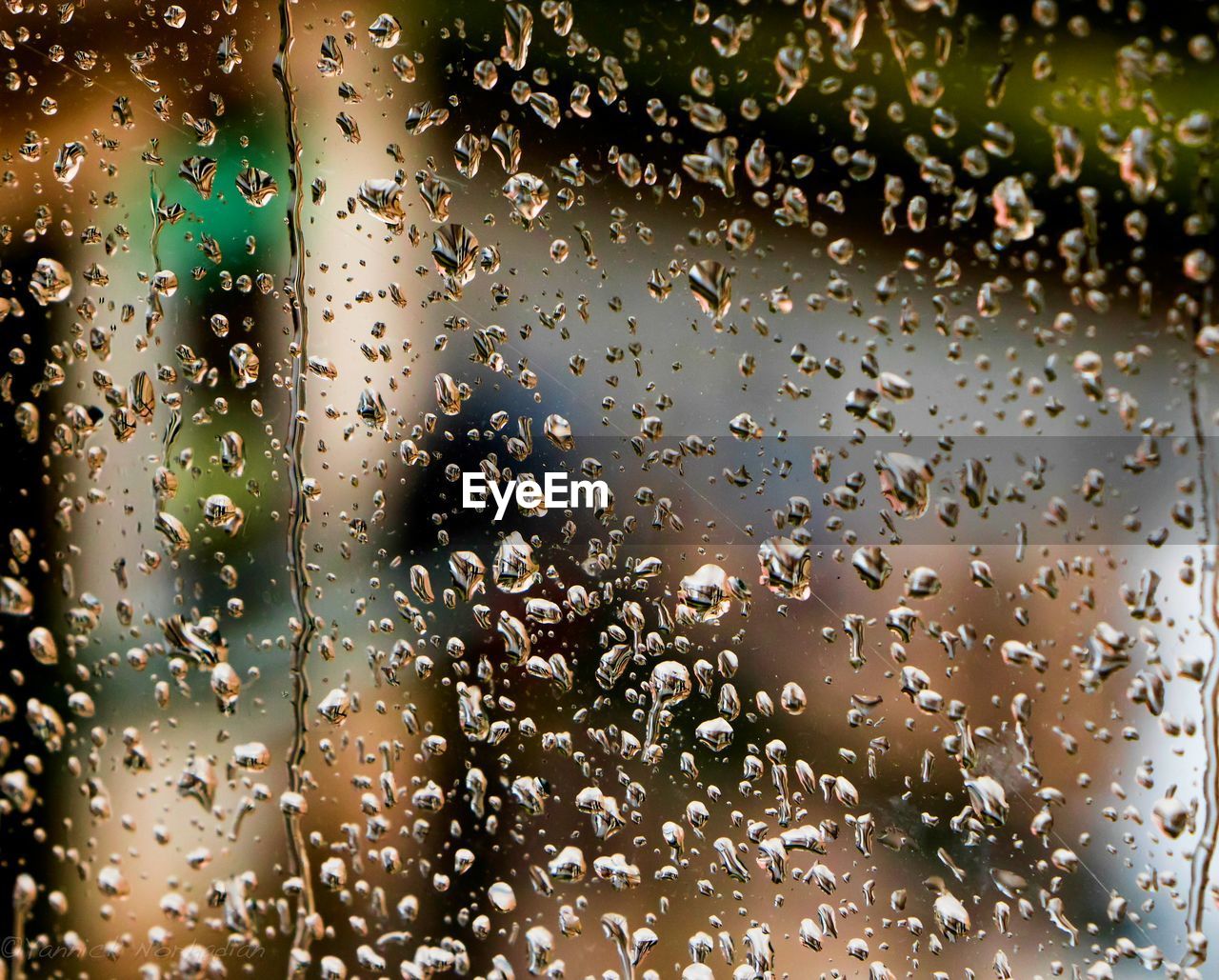 CLOSE-UP OF WATER DROPS ON WINDOW