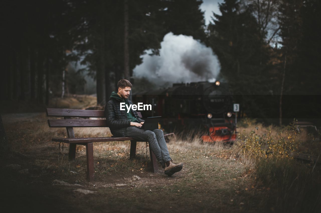 Man sitting on bench in park