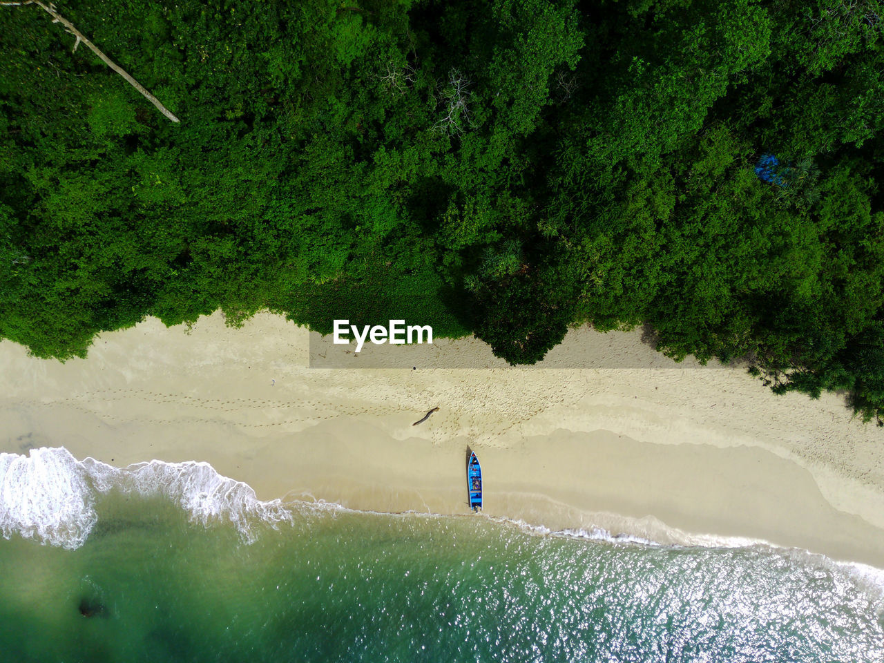 Aerial photo of a traditional boat moored on the beach in teluk ijo, banyuwangi. indonesia.