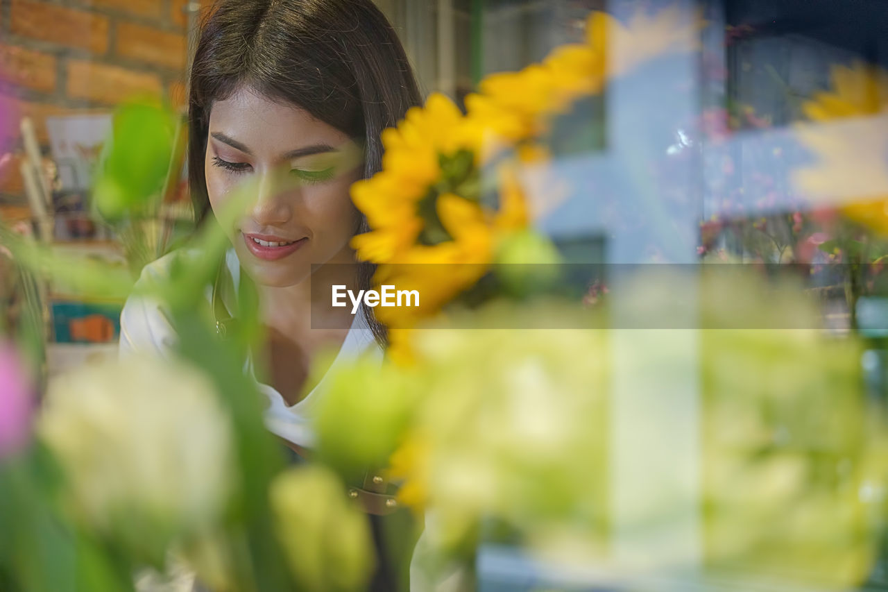 Young woman seen through store window