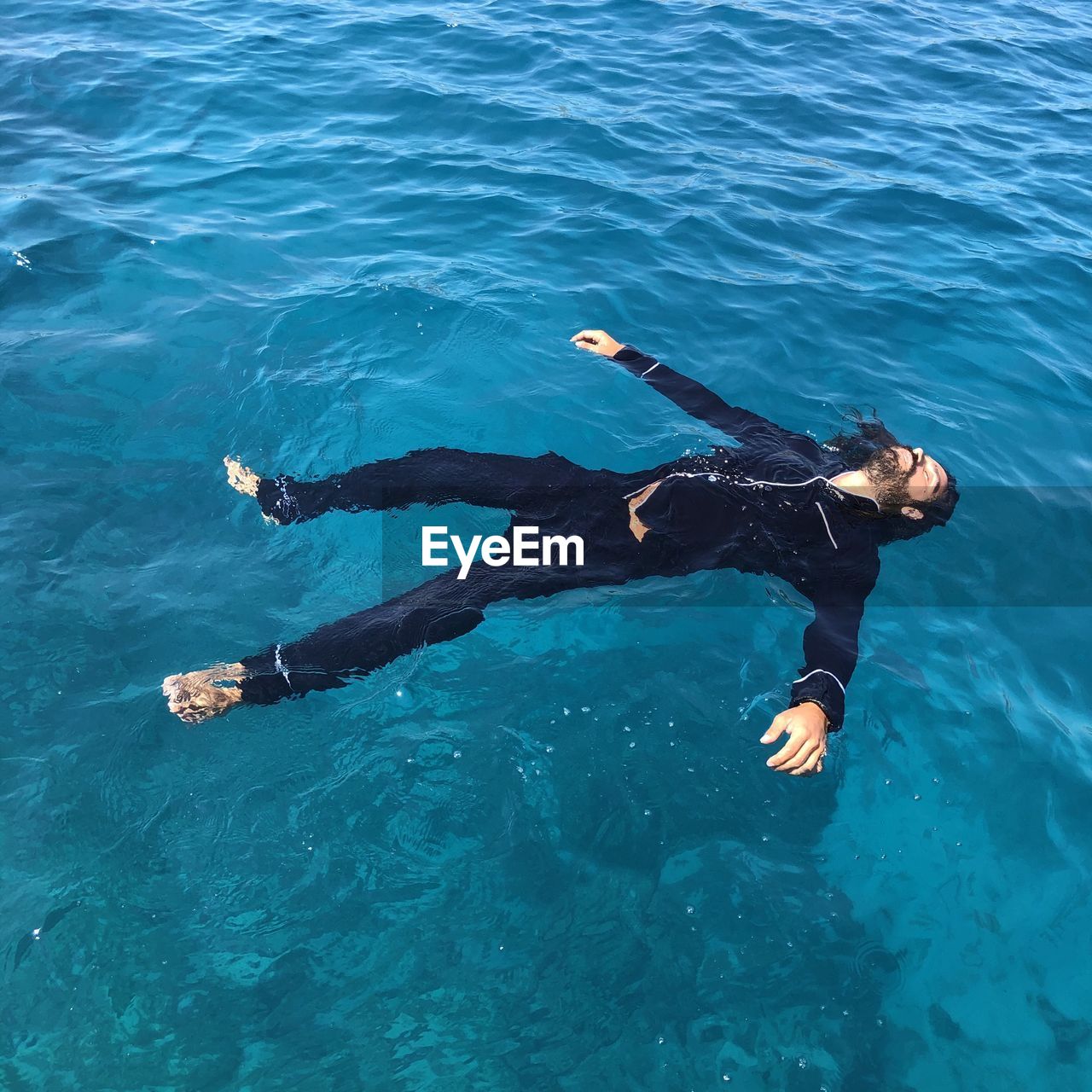 High angle view of man floating on sea