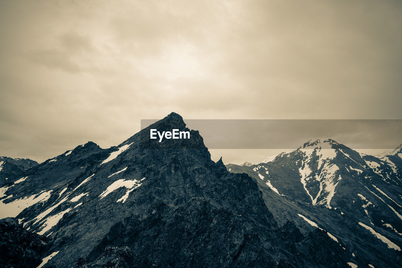 SNOWCAPPED MOUNTAINS AGAINST SKY