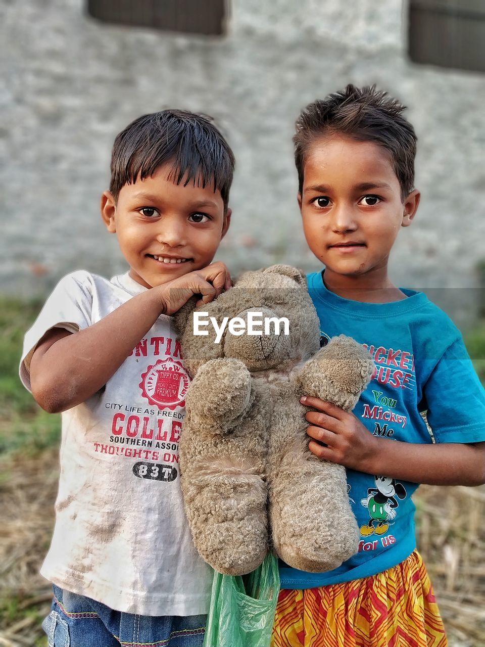 PORTRAIT OF CUTE BOY WITH TOY IN MOUTH