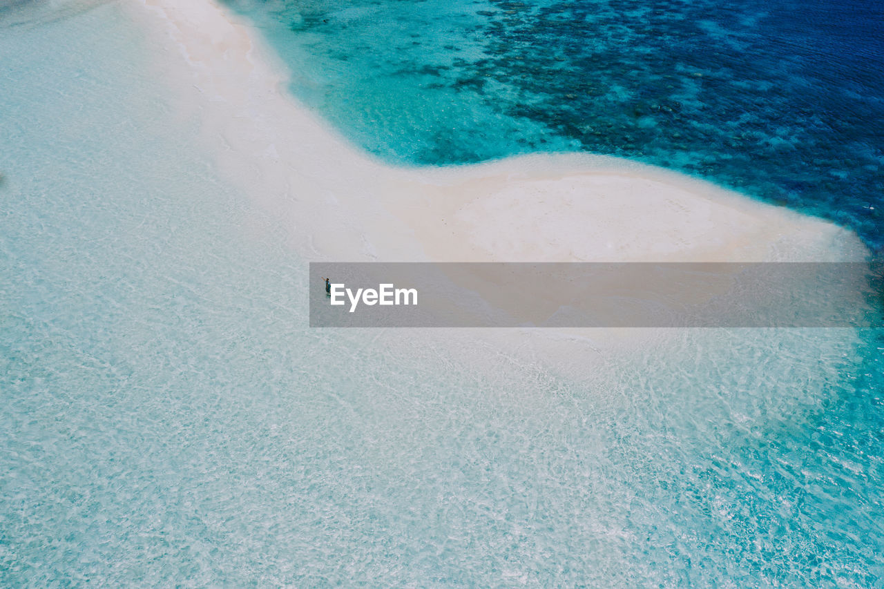 Drone view of man at beach on sunny day