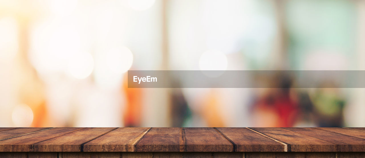 CLOSE-UP OF WOODEN TABLE AT HOME