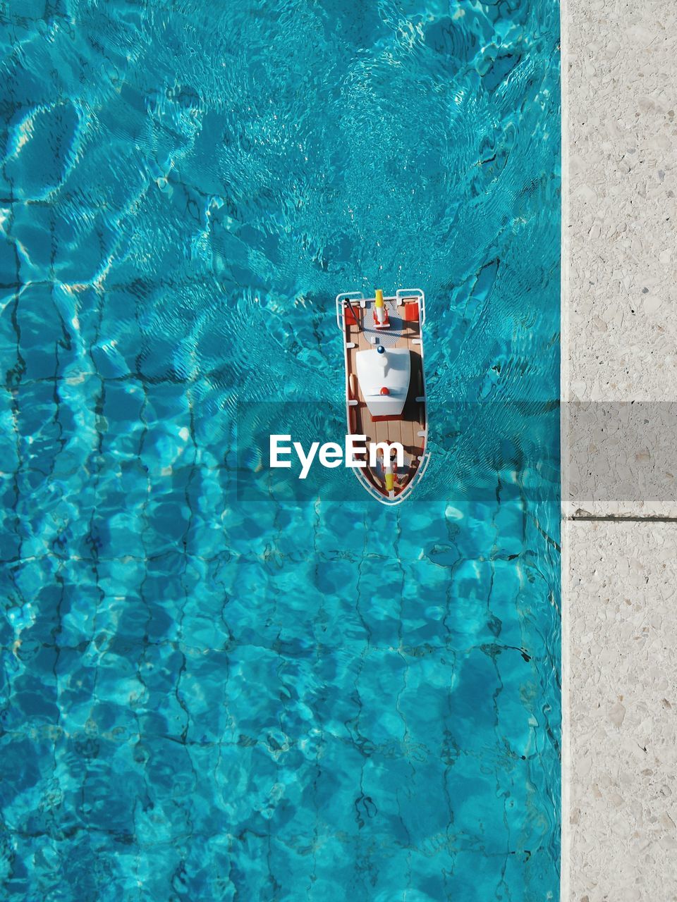 High angle view of toy boat in swimming pool