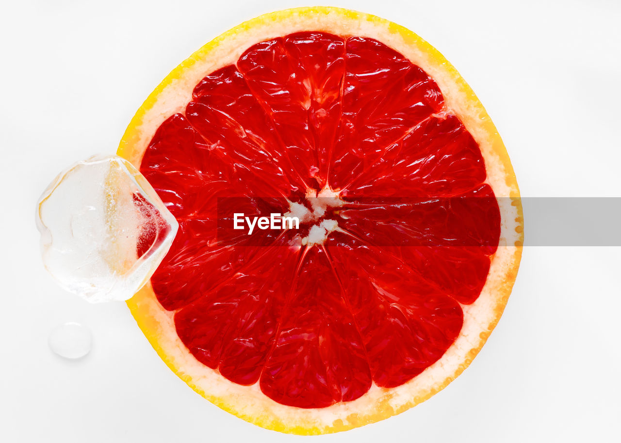 Close-up of blood orange over white background