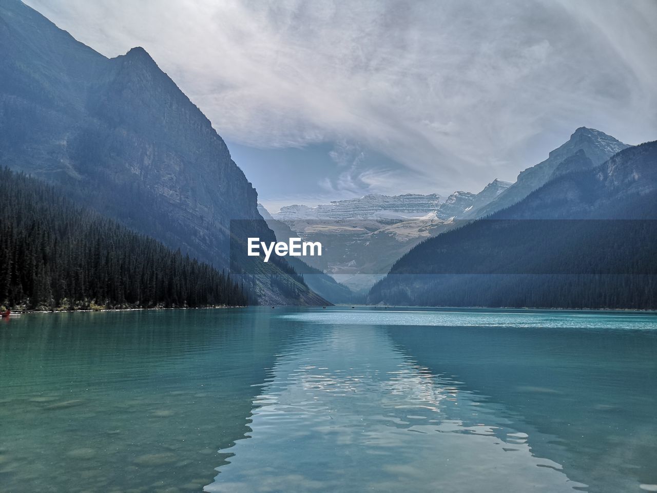 Scenic view of lake and mountains against sky